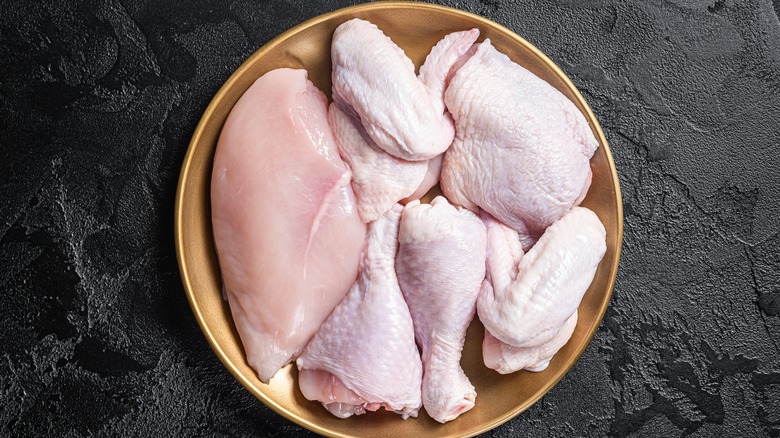 Cuts of chicken on plate