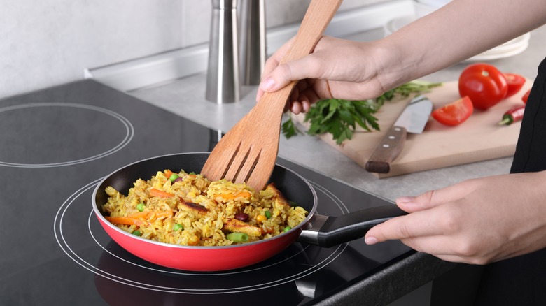 woman cooking on induction stove