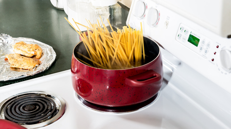 pasta cooking in red pot