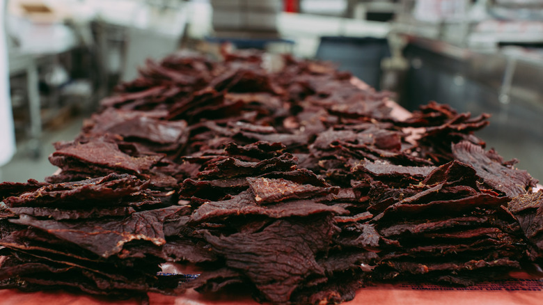 Piles of beef jerky in an industrial kitchen