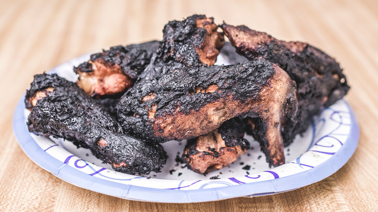 burnt chicken wings on a plate