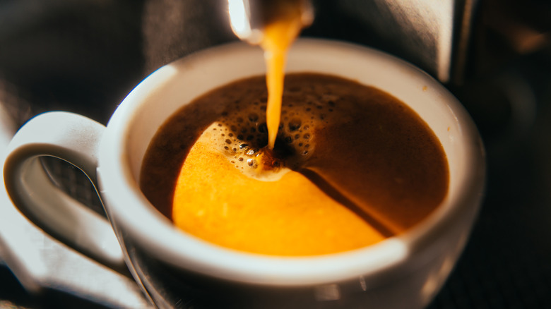 espresso coffee pouring into cup