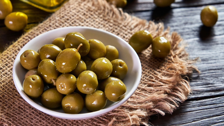 bowl of olives on tablecloth