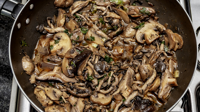 Mushrooms sautéeing in pan