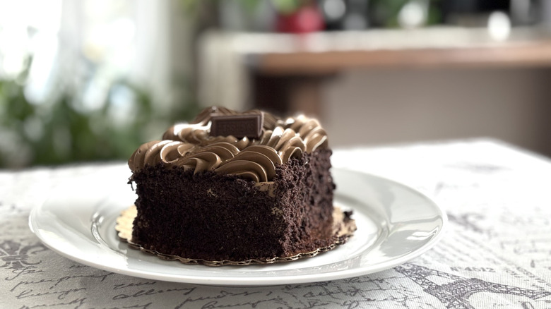 A slice of Safeway Hershey's Bistro Cake on a white ceramic plate