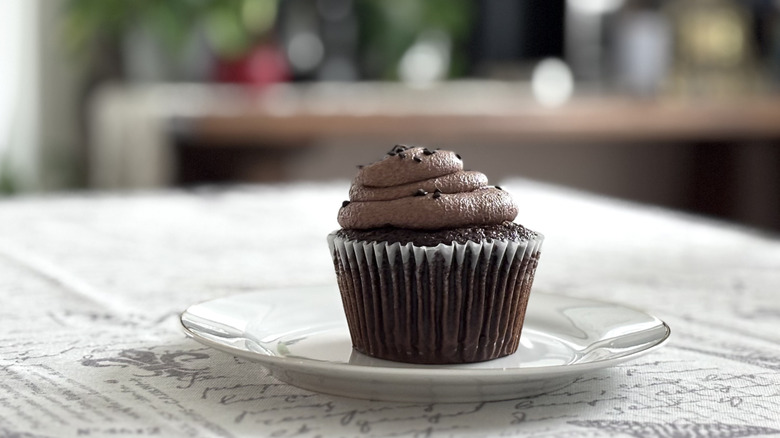 A Private Selection Triple Chocolate Cupcake on a white ceramic plate