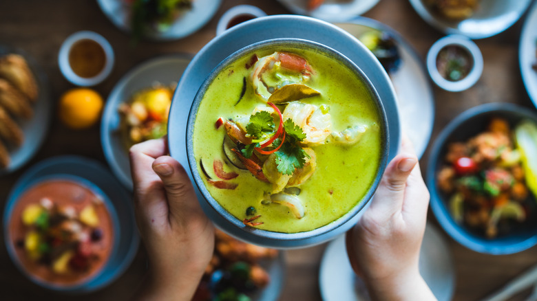 Hand holding green curry