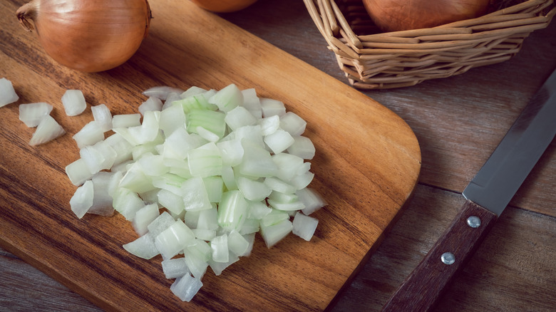 Chopped yellow onions on cutting board