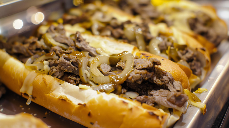 Three cheesesteaks ready to be served