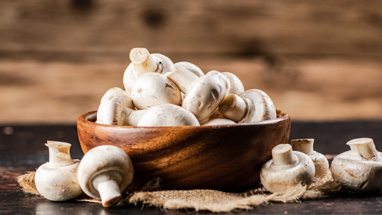 white mushrooms in wooden bowl