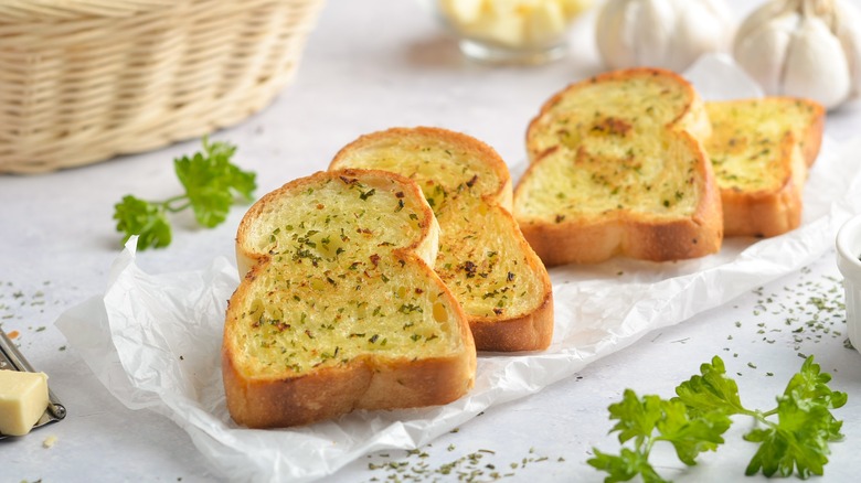 Garlic bread on white table