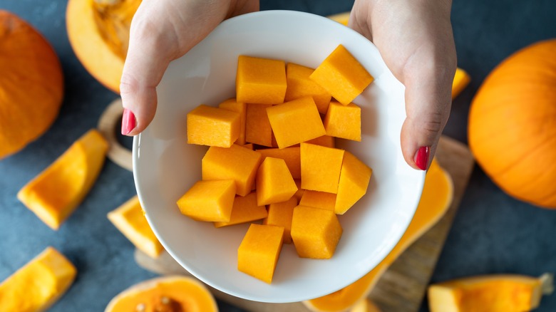 cubes of squash in a white ceramic bowl