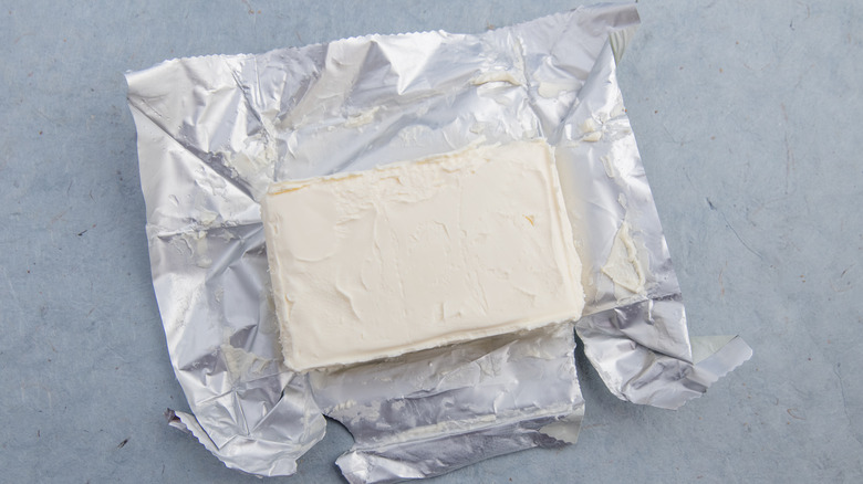 cream cheese block sits on open foil packet