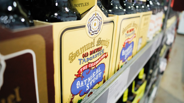 Bottles of Samuel Smith oatmeal stout on a store shelf