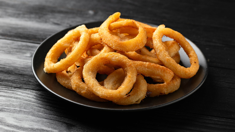 onion rings on a black plate
