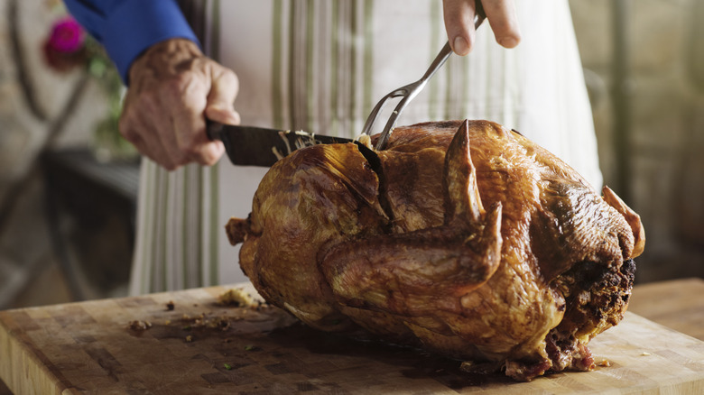 man carving a turkey