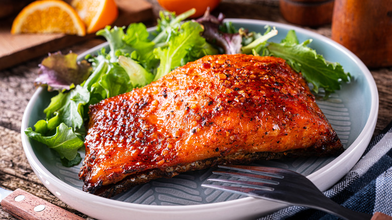 crispy glazed salmon served on plate with salad