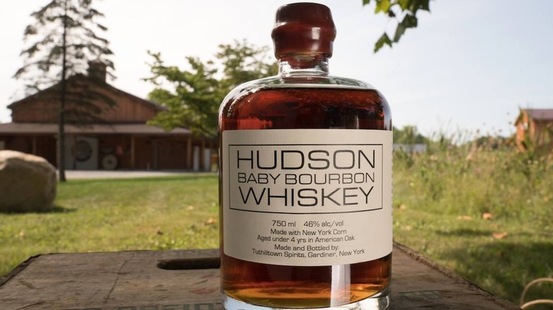 Hudson Baby Bourbon Whiskey bottle on crate outside