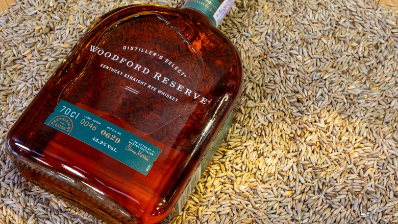 Bottle of Woodford Reserve lying on bed of grains