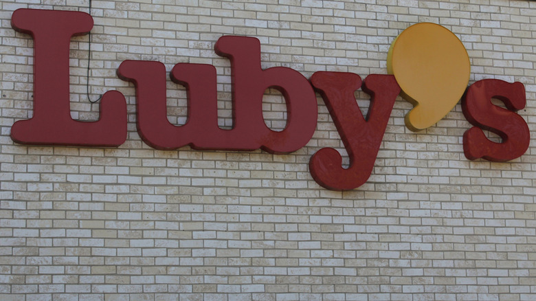A Luby's sign on a brick wall