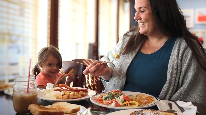 Mother and child eating together at restaurant