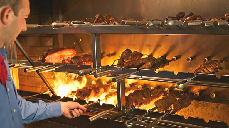 Chef grilling meats at steakhouse