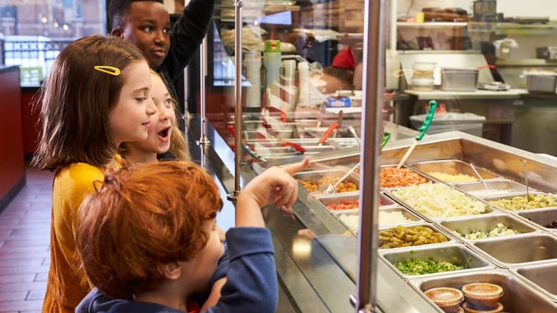 Kids standing at restaurant counter