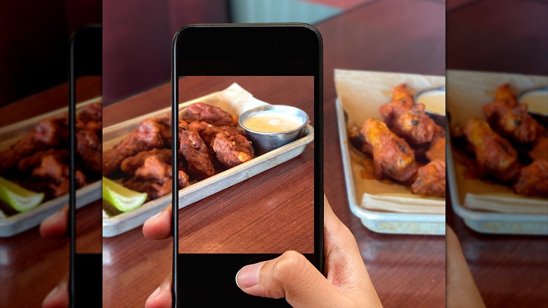 Person taking food picture with phone