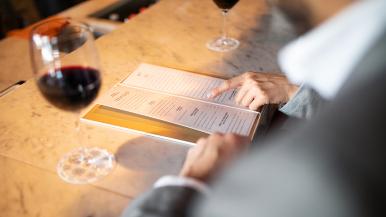 Customers reading wine list