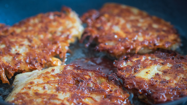 hash browns cooking in pan