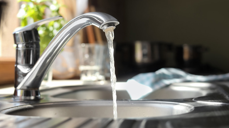 water running from a silver faucet