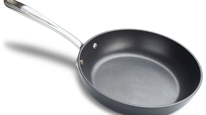 stainless steel frying pan on white background