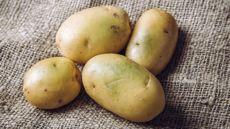 green wax potatoes sitting on burlap