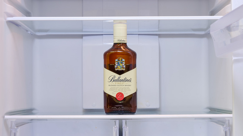 A whiskey bottle in a fridge 