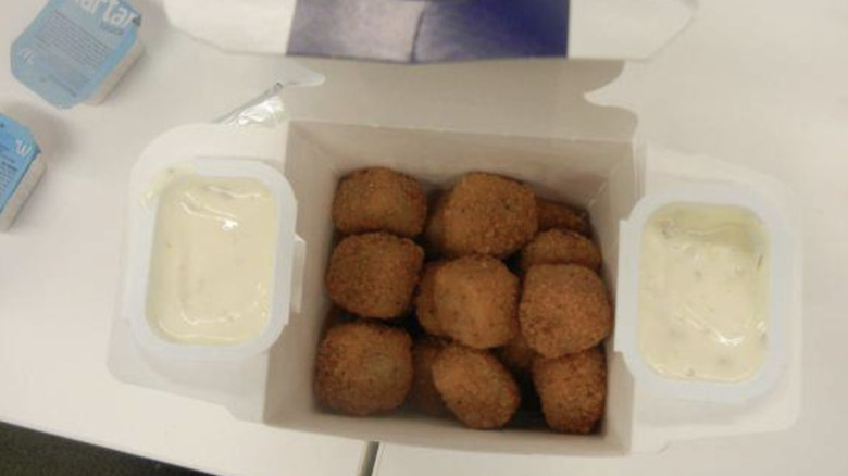 Open box of Fish McBites with two containers of tartar sauce