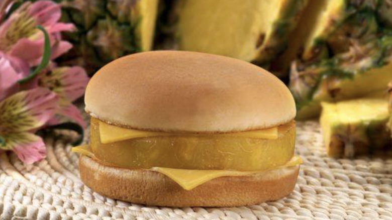 McDonald's Hula Burger with pineapple slices and flowers in background