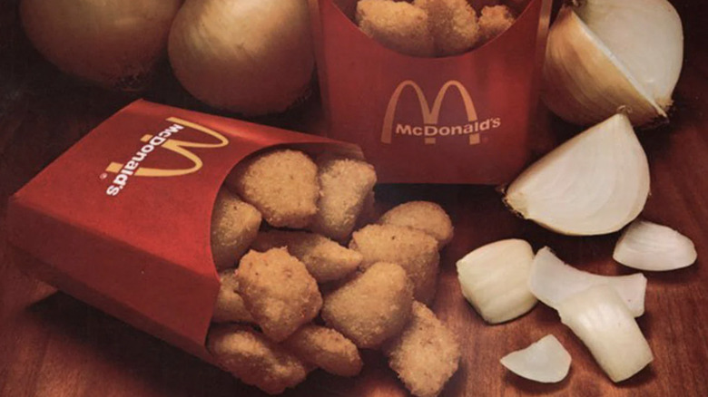 Overflowing carton of McDonald's Onion Nuggets on brown table