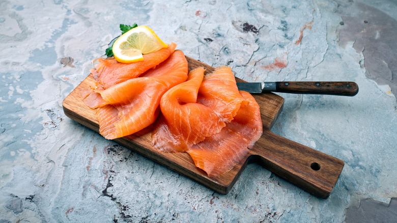 filets of smoked salmon on wooden cutting board