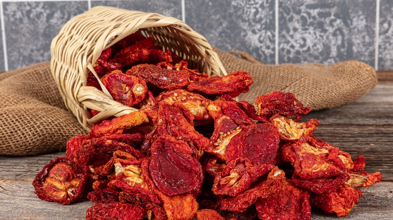 woven basket with sun-dried tomatoes spilling out