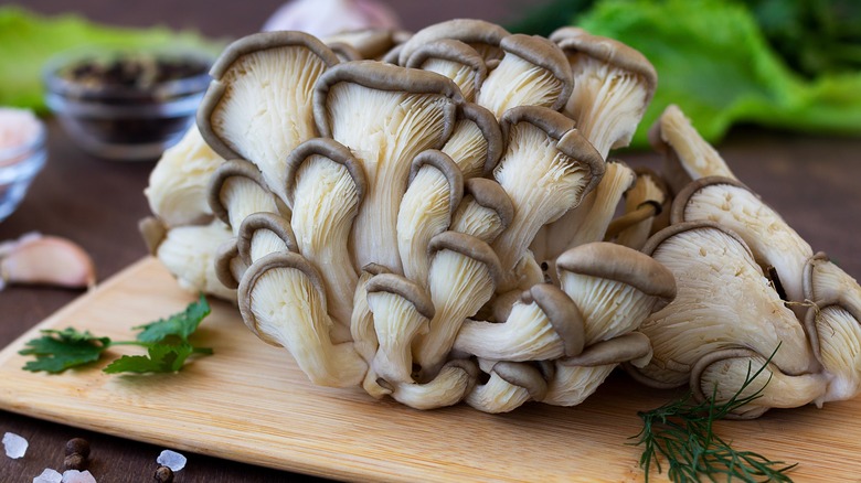 oyster mushrooms on wooden cutting board