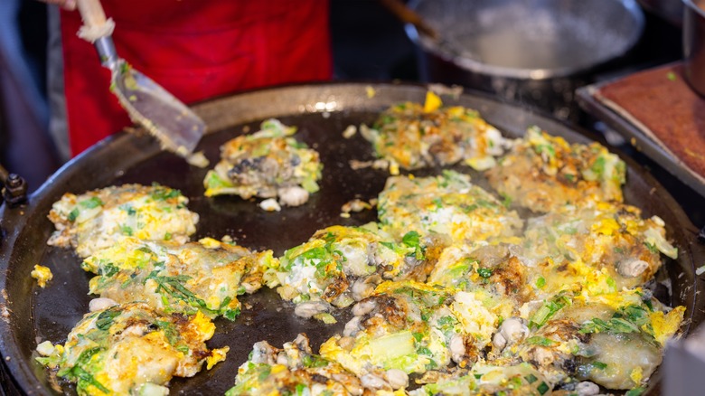 oyster pancakes cooking on pan