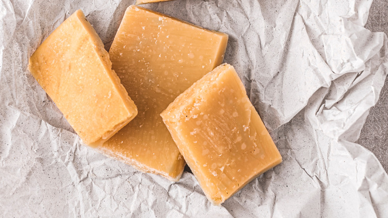 Parmesan cheese rinds sit on a paper