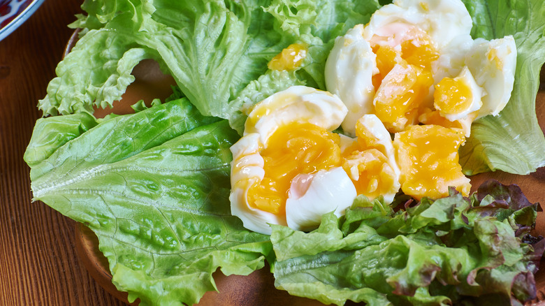 Soft-boiled eggs on lettuce