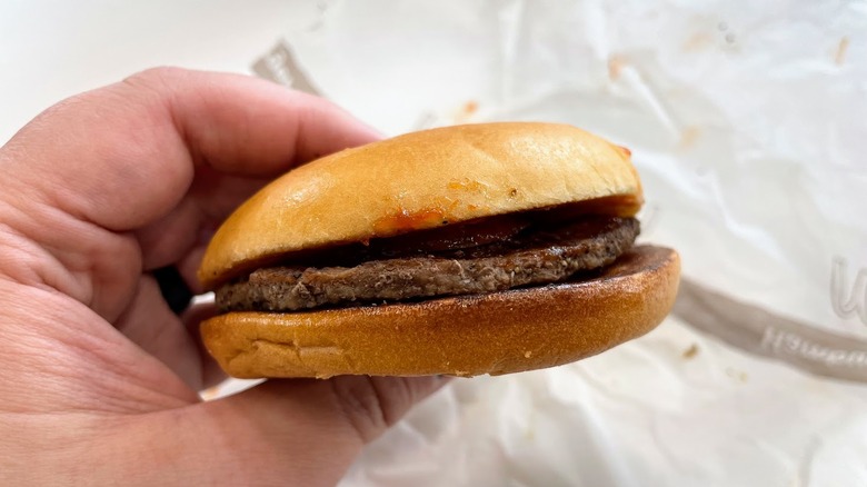 A McDonald's burger with ketchup and pickles