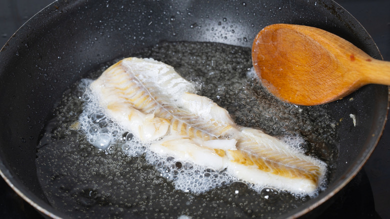 White fish cooking in hot pan