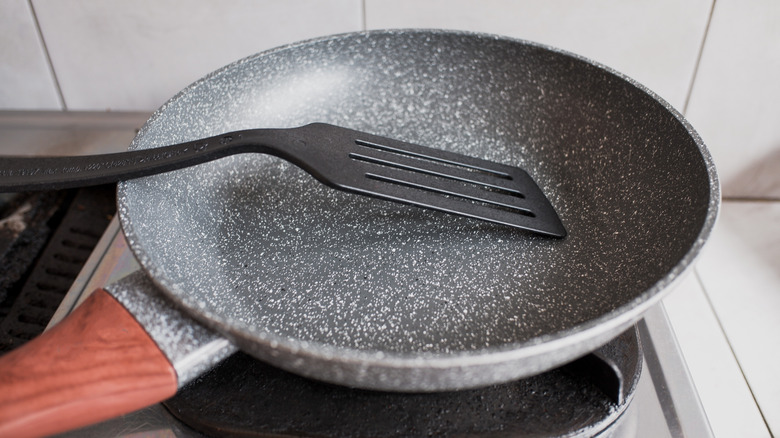 Nonstick pan on stovetop with plastic spatula