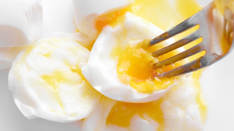 Poached egg pierced with fork