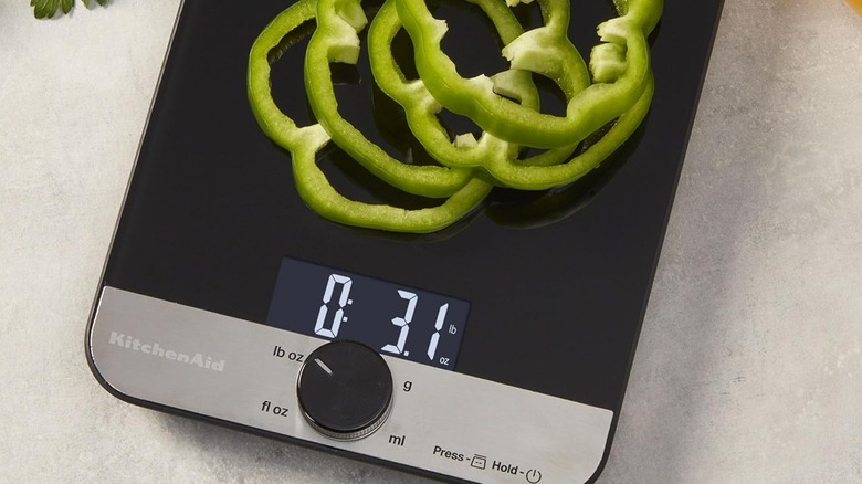 Sliced bell peppers on a KitchenAid digital scale