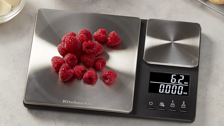 A KitchenAid digital scale weighing raspberries