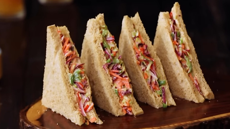 Vegetarian coleslaw sandwiches on a bread board